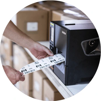 Brother black label machine printing label with barcode, hand holding labels