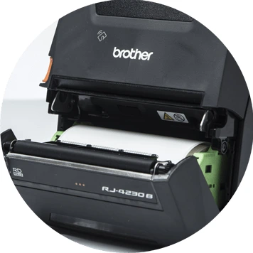 Brother RJ mobile printer open showing roll of white labels
