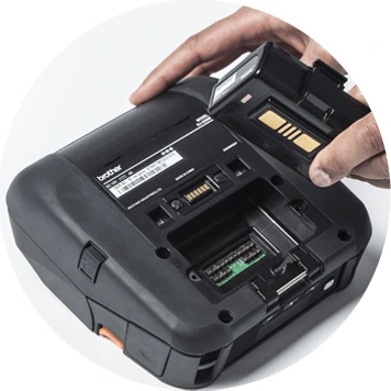 Hand taking battery out of a mobile printer