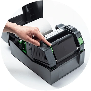 Brother TD-4T desktop label printer open with hand rolling thermal ribbon