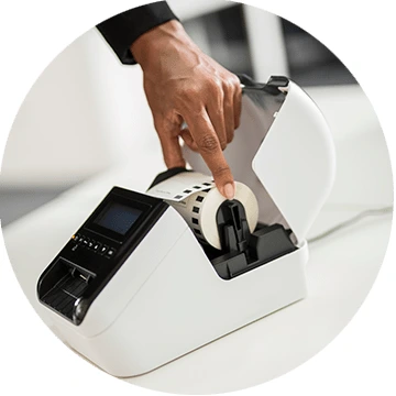 Label roll being installed in Brother QL desktop printer