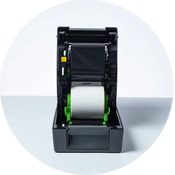 Brother TD-4T desktop label printer open with labels and ribbons on show