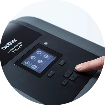 Brother TD-4T desktop label printer with finger pressing buttons