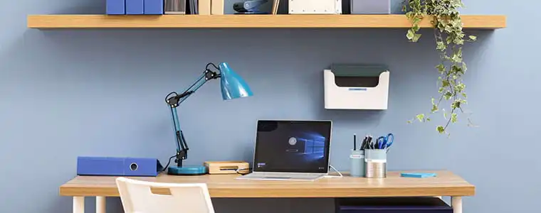 Office with desk lamp, desk, laptop, plan, stationary