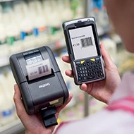 worker in a supermarket using Brother RJ printer